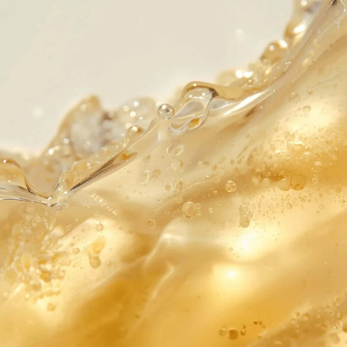 Close-up of golden liquid showcasing the texture and clarity of the vitamin C serum. DOS Cosmetics