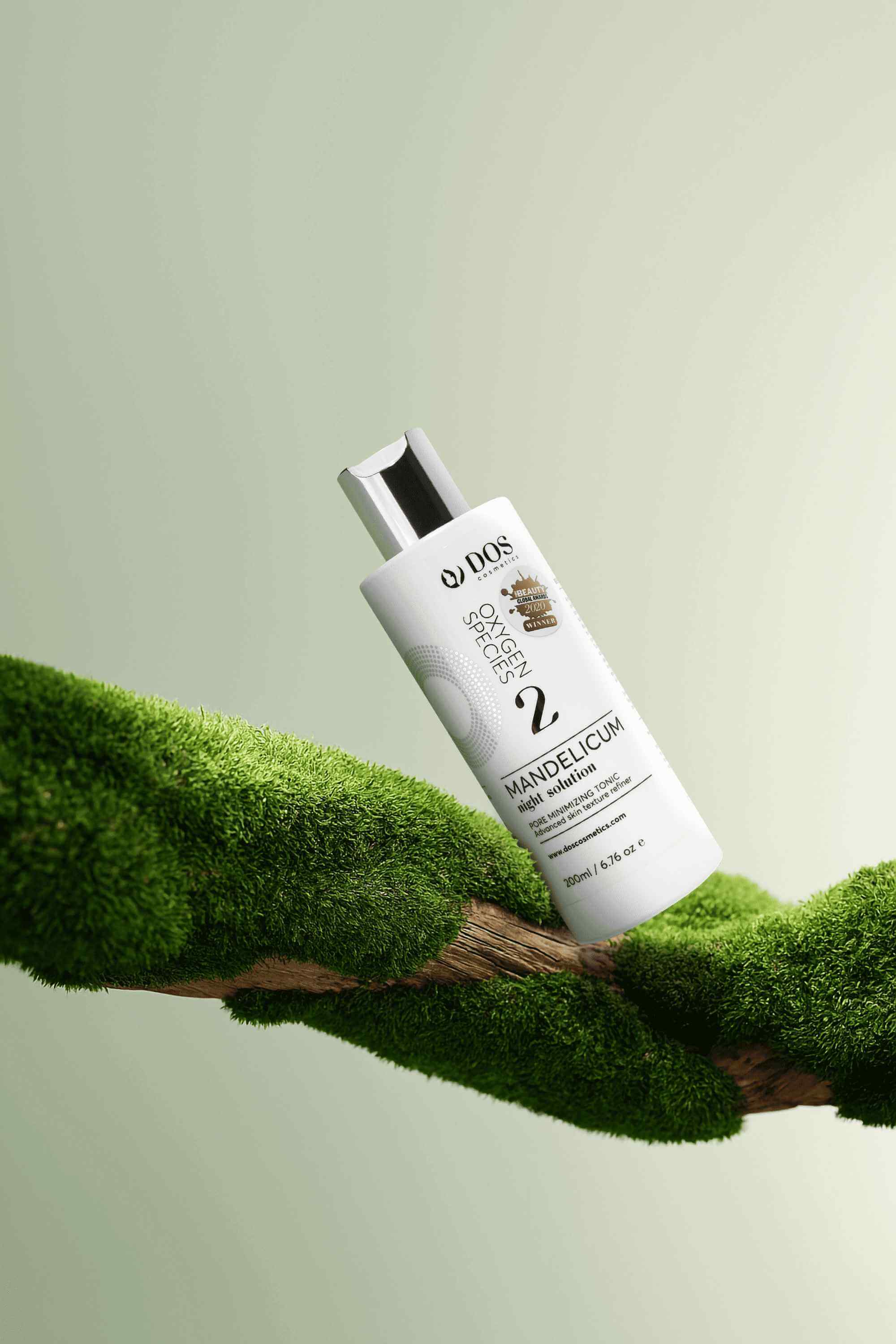 Mandelic Acid Solution displayed on a green mossy surface, emphasizing its exfoliation and hydration benefits. DOS Cosmetics