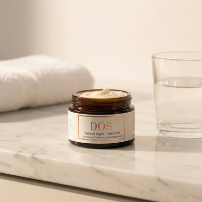 DOS Retinol night cream on a marble surface with a glass and towel in the background showing texture
