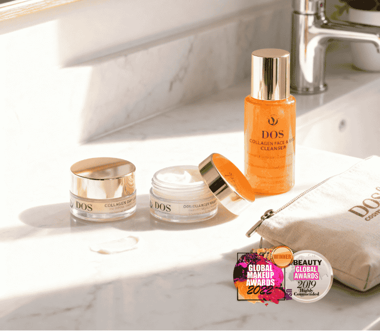 Cosmetic products on a bathroom counter with awards displayed. DOS Cosmetics