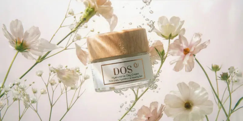 hyaluronic day cream labeled 'DOS' surrounded by flowers on a light background