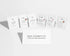Six small white skincare sachets arranged in a row on a light gray background, with a white card in front reading &