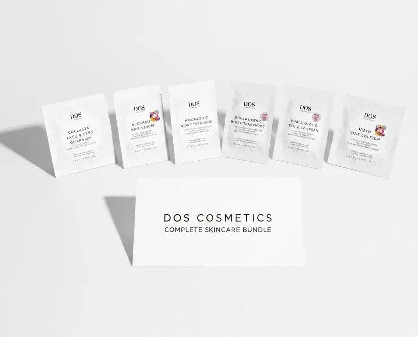 Six small white skincare sachets arranged in a row on a light gray background, with a white card in front reading &